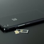 black smartphone on black table top